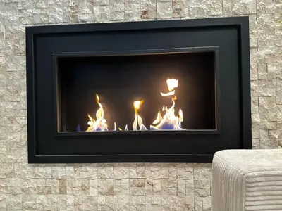 a fireplace with a fire in it at Triplex with garden and parking in Belgrade
