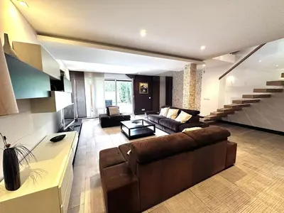 a large living room with a couch and a table at Triplex with garden and parking in Belgrade