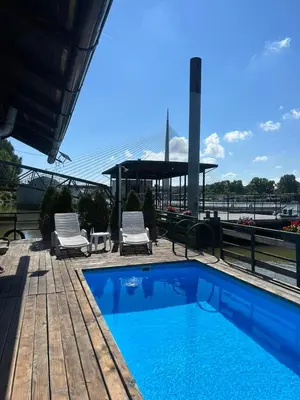 a swimming pool with two chairs and a gazebo at Splav na Savi KALIVARIJA in Belgrade