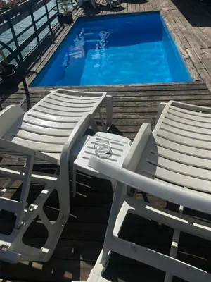two lounge chairs and a swimming pool at Splav na Savi KALIVARIJA in Belgrade