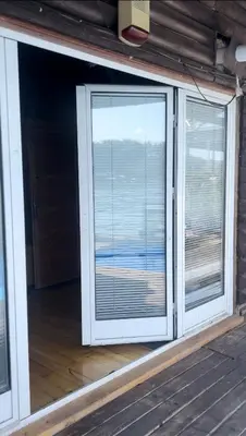 a room with a large window with blinds at Splav na Savi KALIVARIJA in Belgrade