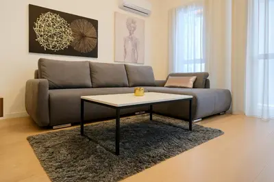 a living room with a couch and a coffee table at Queen's Park Residence Apartments in Belgrade
