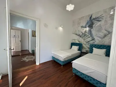 a living room with two beds and a couch at Eight Apartment in Belgrade