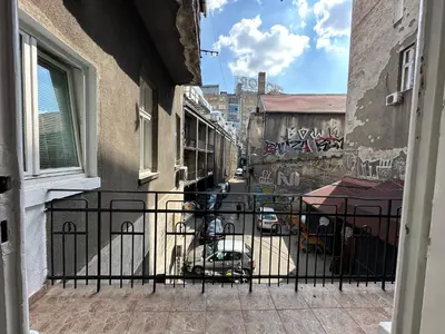 a view from a balcony of a street with graffiti at Eight Apartment in Belgrade
