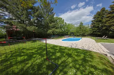 a fence around a swimming pool in a yard at Avalavanda Cherry Hill in Vlasi