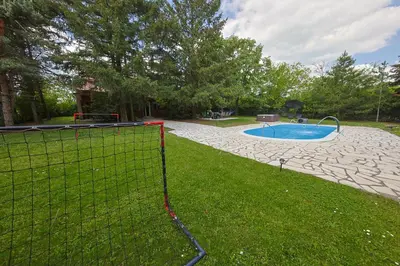 a fence around a swimming pool in a yard at Avalavanda Cherry Hill in Vlasi