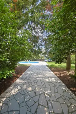 a stone walkway in a park with trees at Avalavanda Cherry Hill in Vlasi