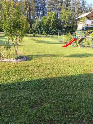 a park with a playground with a red slide at Nasa kuca in Gročanska Ada