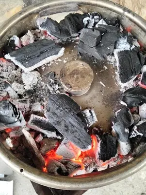 a pan full of food with a fire in it at Nasa kuca in Gročanska Ada