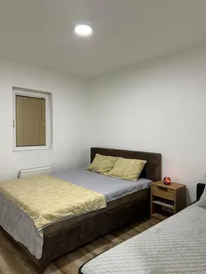 a bedroom with two beds and a window at DP Lux apartman Obrenovac,sa parkingom in Obrenovac