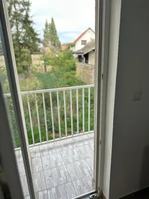 a sliding glass door with a view of a balcony at DP Lux apartman Obrenovac,sa parkingom in Obrenovac