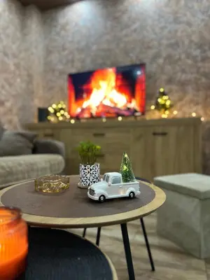 a toy car with a christmas tree on top of a table at DP Lux apartman Obrenovac,sa parkingom in Obrenovac
