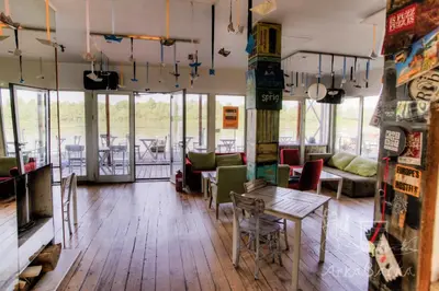 a living room with a table and chairs in a room at ArkaBarka 2- Floating Dream Rooms and Apartments in Belgrade