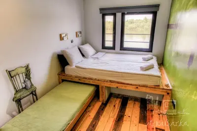 a small bedroom with a bed and a window at ArkaBarka 2- Floating Dream Rooms and Apartments in Belgrade