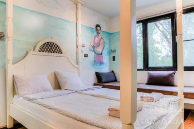 a bedroom with a bed and a painting on the wall at ArkaBarka 2- Floating Dream Rooms and Apartments in Belgrade