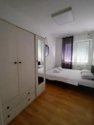 a bedroom with two beds and a large mirror at Benvenuti HONEY in Zemun