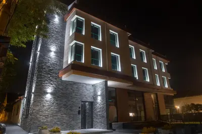 a large building with lights on it at night at Benvenuti HONEY in Zemun