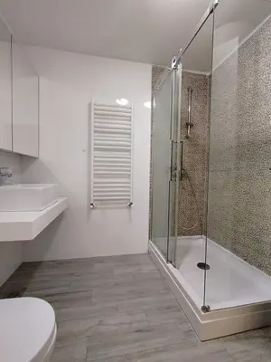 a bathroom with a shower and a toilet and a sink at Benvenuti HONEY in Zemun