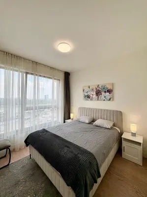 a bedroom with a large bed and a large window at BW Aqua Waterside Sandy in Belgrade