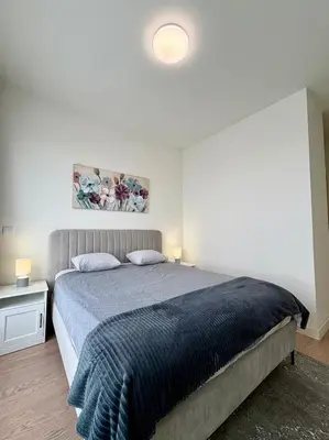 a bedroom with a bed with a blue blanket at BW Aqua Waterside Sandy in Belgrade