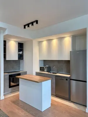 a kitchen with stainless steel appliances and a counter top at BW Aqua Waterside Sandy in Belgrade
