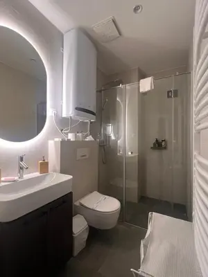 a bathroom with a toilet and a sink and a shower at K-District Apartment Charlie in Belgrade