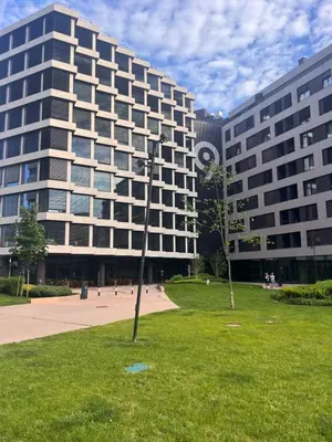 a building with a pole in the grass in front of it at K-District Apartment Charlie in Belgrade