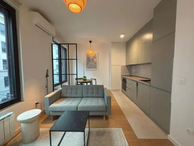 a living room with a couch and a table at K-District Apartment Charlie in Belgrade