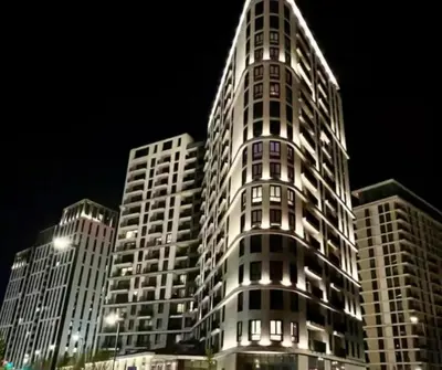 a tall building at night with lights on it at Beograd na vodi - Belgrade Waterfront Luna Apartment in Belgrade