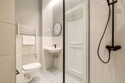 a bathroom with a toilet and a sink and a shower at High Note Suites in Belgrade
