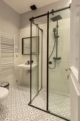 a bathroom with a shower and a toilet and a sink at High Note Suites in Belgrade