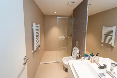 a bathroom with a sink and a toilet and a shower at Talija BW in Belgrade