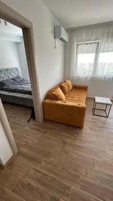 a living room with a couch and a bed at Stan na dan Indjija in Inđija
