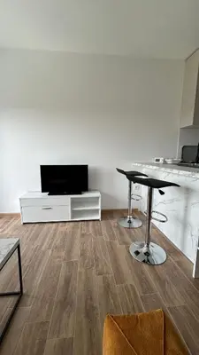 a living room with a table and a counter at Stan na dan Indjija in Inđija