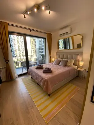 a bedroom with a large bed and a large window at Belgrade Waterfont, Symphony 1, Studio 307 in Belgrade