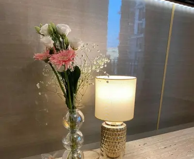 a vase with flowers and a lamp on a table at Belgrade Waterfont, Symphony 1, Studio 307 in Belgrade