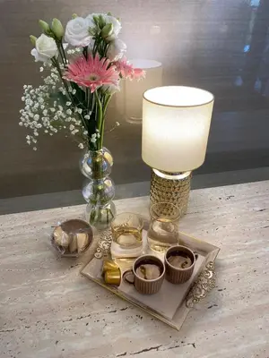 a table with a vase of flowers and a lamp at Belgrade Waterfont, Symphony 1, Studio 307 in Belgrade