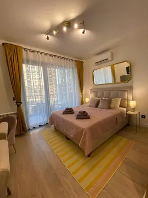 a bedroom with a bed and a large window at Belgrade Waterfont, Symphony 1, Studio 307 in Belgrade