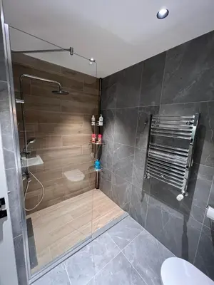 a bathroom with a shower with a glass door at Belgrade Waterfont, Symphony 1, Studio 307 in Belgrade