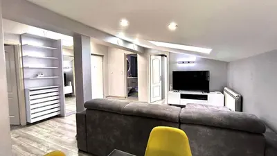 a living room with a couch and a television at Long Term Savamala 2BDR for 4 Long Term in Belgrade