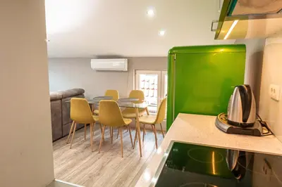 a kitchen and dining room with a table and chairs at Long Term Savamala 2BDR for 4 Long Term in Belgrade