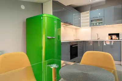 a green refrigerator in a kitchen with two chairs at Long Term Savamala 2BDR for 4 Long Term in Belgrade