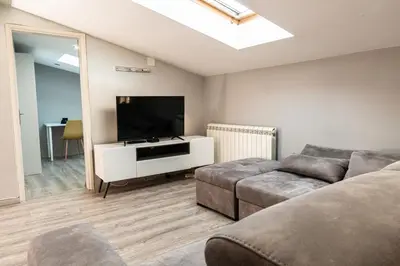 a living room with a couch and a flat screen tv at Long Term Savamala 2BDR for 4 Long Term in Belgrade