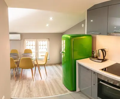 a green refrigerator in a kitchen with a table at Long Term Savamala 2BDR for 4 Long Term in Belgrade