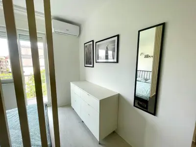 a bedroom with a white dresser and two mirrors at Apartment LUX 15 Historical Center Belgrade in Belgrade