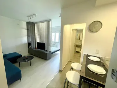 a living room with a blue couch and a table at Apartment LUX 15 Historical Center Belgrade in Belgrade