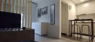 a living room with a flat screen tv and a kitchen at Apartment LUX 15 Historical Center Belgrade in Belgrade