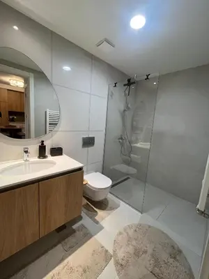 a bathroom with a shower and a sink and a toilet at Belgrade Waterfront Dream in Belgrade