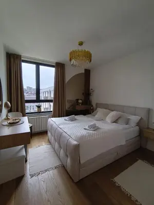 a bedroom with a large bed and a large window at Belgrade Waterfront Dream in Belgrade