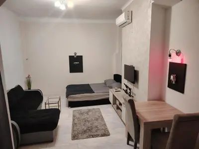 a small living room with a bed and a couch at Pablo MovieSTAR in Belgrade